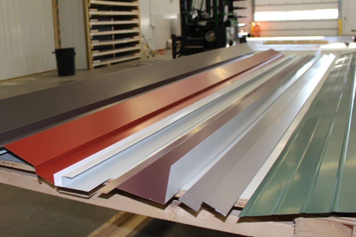 Metal trim pieces of different shapes and colors laid out on a table available for sale near Wilmington, Delaware
