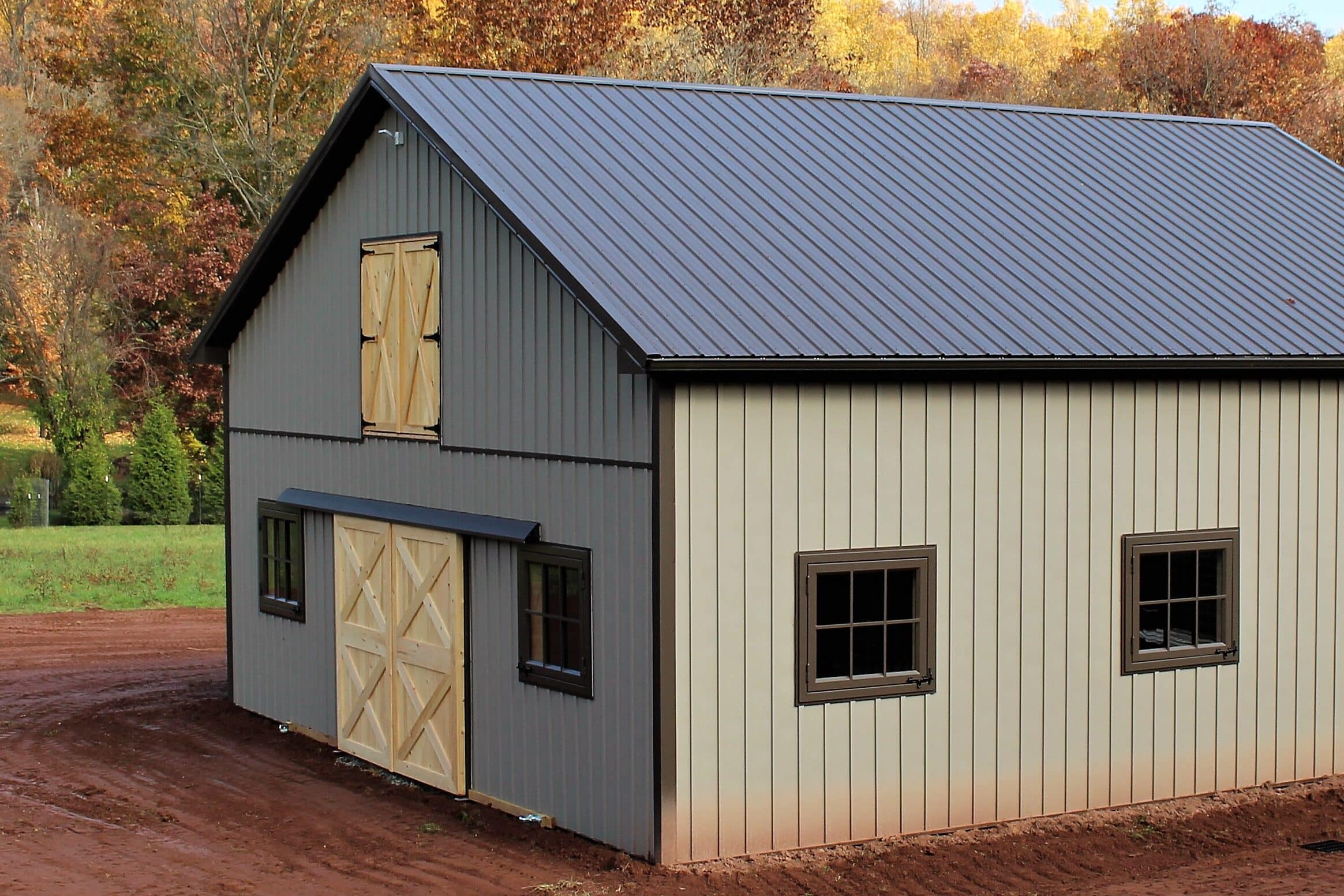 New shed with gray Board and Batten metal siding and metal roof